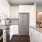 Three-Bedroom Luxury Apartments in Eagan, MN - Viking Lakes Residences - Modern Kitchen with Light Interior Finishes, Center-Island Gourmet Kitchen Table and Counter Stools, Stainless Steel Appliances, Including a Gas Stove, White Oversized Custom Cabinet