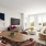 Eagan, MN Luxury Apartments with In-Unit Washer and Dryer - Viking Lakes Residences - Bright Living Room Adjacent to the Dining Area in an Open Layout with Modern and Elegant Decor, Natural Light Comes in through an Oversized Window, Crisp White Walls, Va
